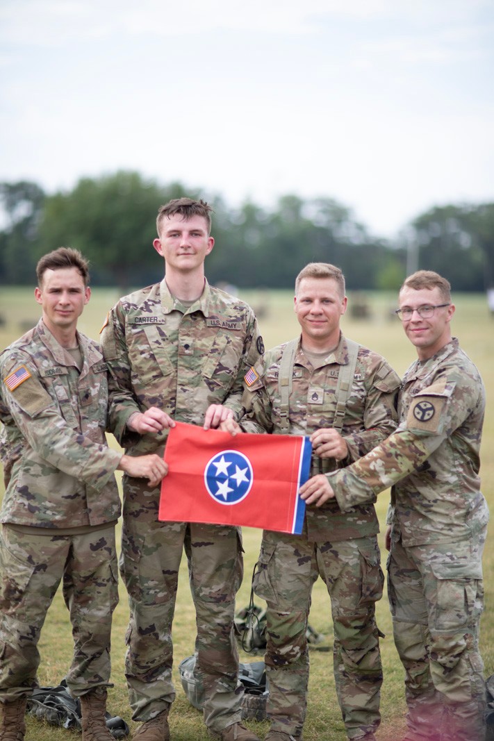 Four Soldiers from Ashland City’s Troop B, 1st Squadron, 278th Armored Cavalry Regiment, won first place during the prestigious 2024 Sullivan Cup competition at Fort Moore, Georgia, from April 29 to May 3. Staff Sgt. David Riddick, Sgt. Joshua Owen, Spc. Noah Eddings, and Spc. Seth Carter hold a Tennessee flag after defeating 10 other teams from active-duty Army units, and four different allied nations, in a head-to-head competition to test a crew's maneuver, sustainment, and gunnery skills to earn the honor of being the best tank crew.  (photo by Staff Sgt. Arturo Guzman) 