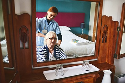 941789624 Smiling elderly woman and a nurse.