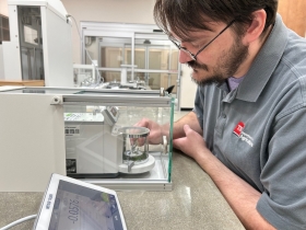 Tennessee Department of Agriculture Metrologist Nick Andersen in the small mass laboratory