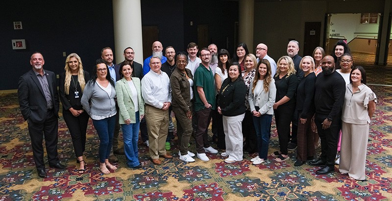 Most of Tennessee's Faith-Based Community Coordinators and Lifeline Peer Project Coordinators pictured at a conference in October 2025.