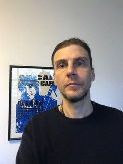 Drew Gilmer There is a photo of Drew with a somewhat serious face, posing in front of a framed concert poster that says “ASCAP” on it
