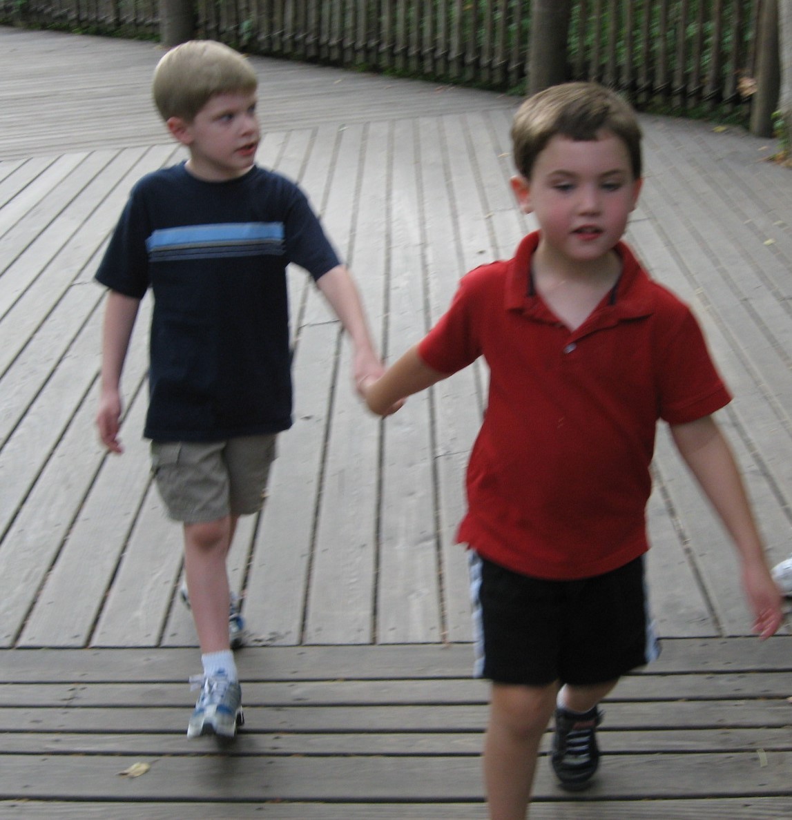 A trip back in time: Aidan and Ryan went to preschool together at Vanderbilt’s Susan Gray School two young boys holding hands on a playground.