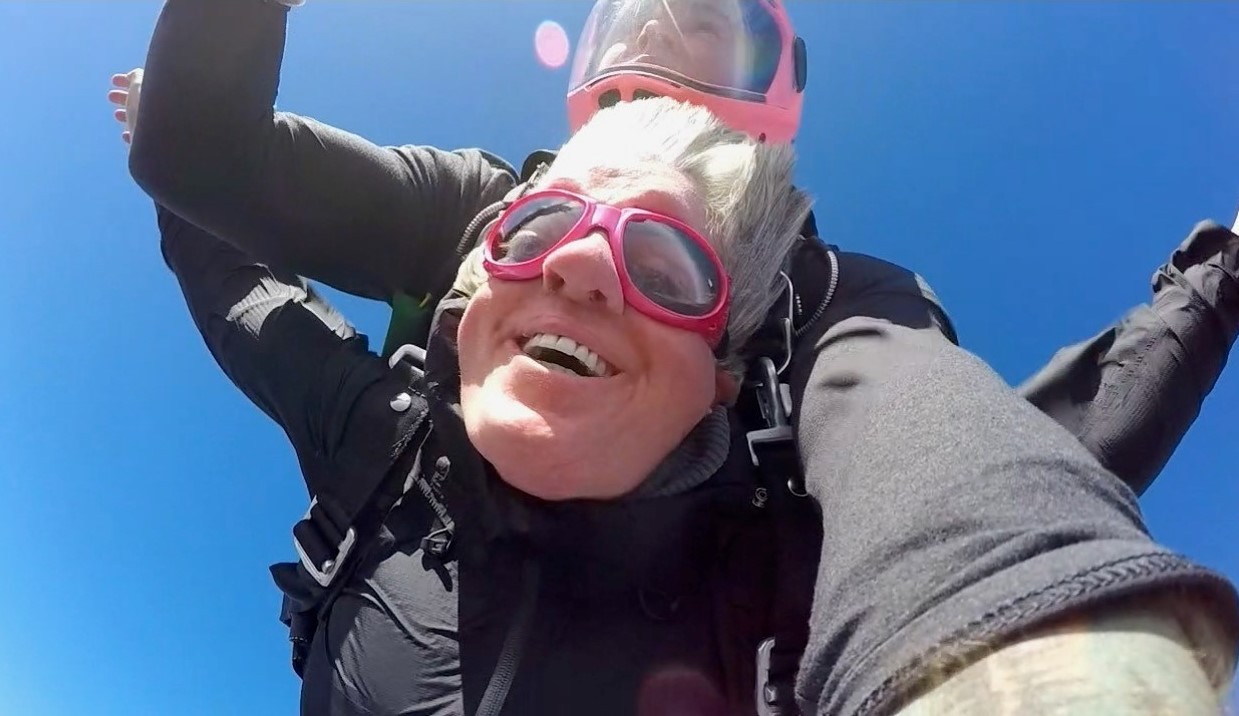 Sarah's skydiving adventure photo 3 A close-up photo of Sarah’s smiling face from right below her