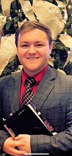 Haiden Partin headshot of Haiden, a young man in a suit with short blonde hair and a smile