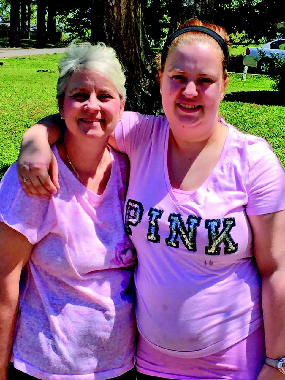 Sheila and Sarah Carson, mother and daughter a photo of the author, Sheila Carson, with her daughter, Sarah. They are both smiling, holding each other and wearing bright pink t-shirts.