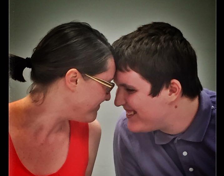  a sweet up close photo of Emma – the article author – and her brother Evan. Their foreheads are touching and they are both smiling