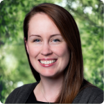 headshot of Ashley Edwards, a white woman with long brown hair, a black shirt and gray sweater