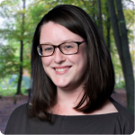 headshot of Emma Shouse Garton, a white woman with short brown hair, brown glasses and an olive green blouse