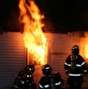 Three Firefighters Three Firefighters in front of a burning house