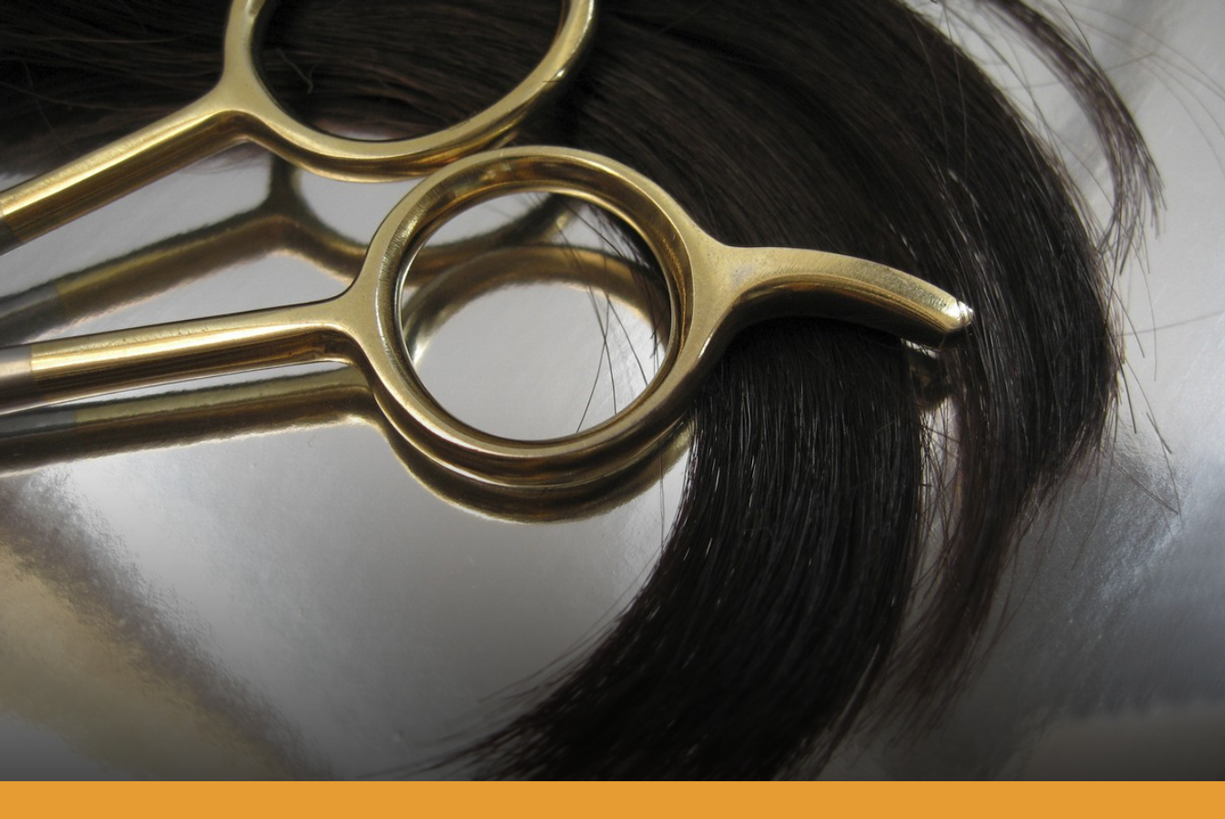 Lock of hair and handle of scissors