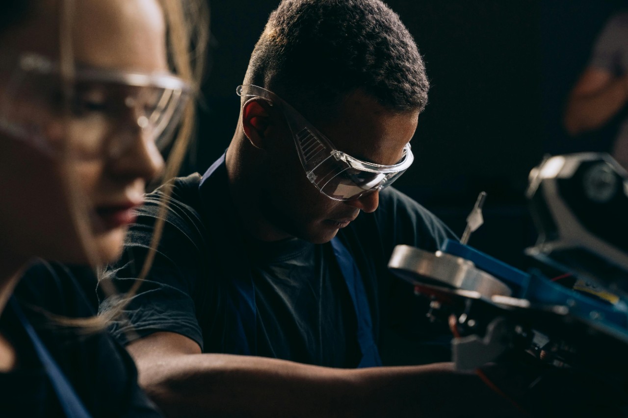 A photo of two workers in manufacturing.