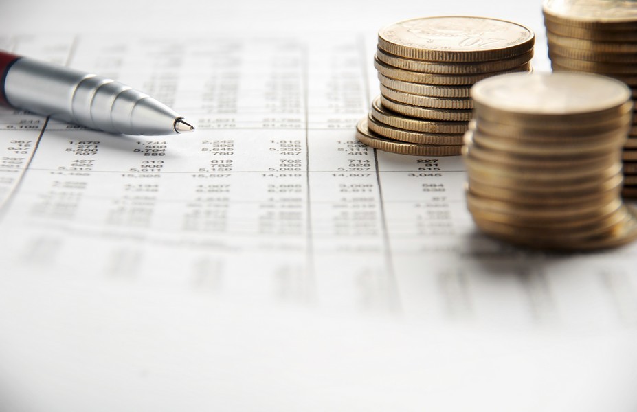 pen, stacks of coins, spreadsheet showing accounting functions