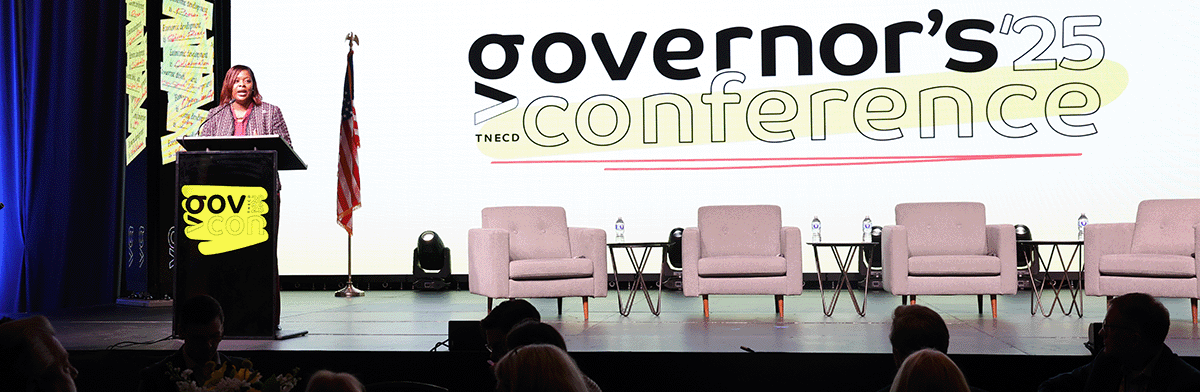 Commissioner Deniece Thomas speaks at a podium in front of a backdrop that says TNECD Governor's Conference 25