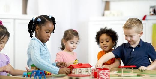four_children_playing_together__full Image of five kids playing together at a table