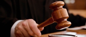 104821184 Photo of hand holding gavel about to hit it on table