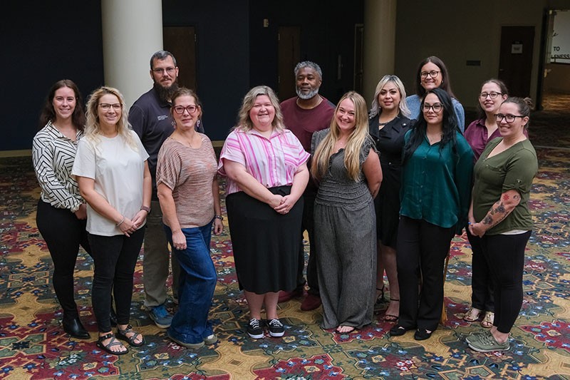 Members of the FR-REST Care Coordination team pose for a group photo with department support staff at a conference in October 2025.