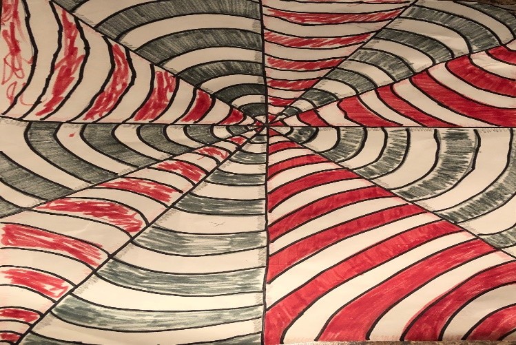 The drawing is divided diagonally from the center, with alternating sections of white and red thick stripes, and blue and white thick stripes. It appears to look like a red, white and blue web