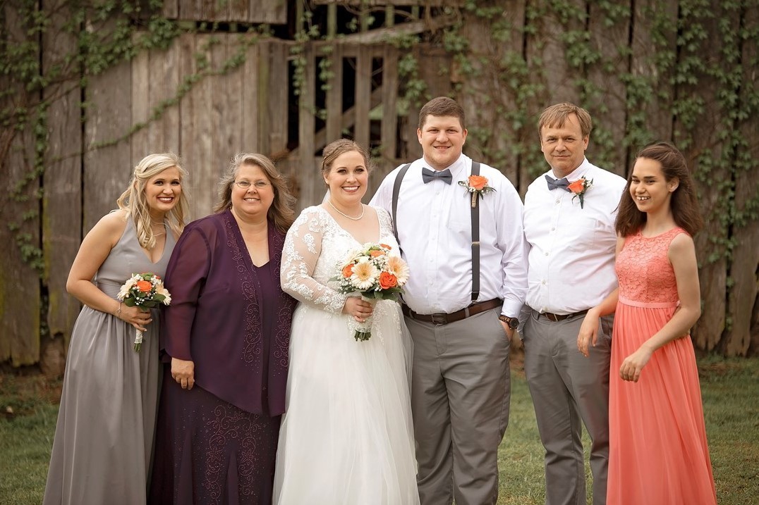 A family photo of the Hood family from a wedding – shows Chrissy, her husband, and three daughters