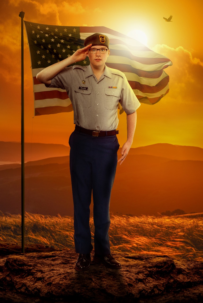 Ryan Wallace • Ryan Wallace’s poster – Ryan, a young adult white man with glasses, is shown saluting the camera with a serious expression on his face and standing at attention. He is wearing a JROTC/military uniform and beret. The background of his poster is outdoors with an American flag blowing in the wind right behind him and mountains and a setting sun in the distance.