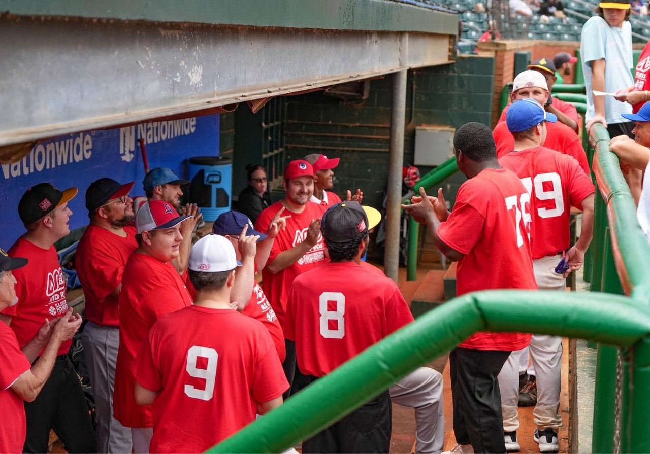 the team in red jerseys in their dugout