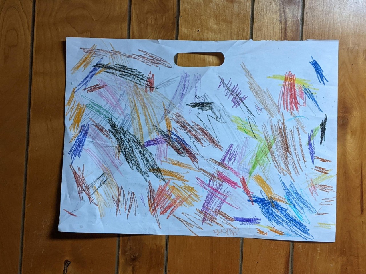 the actual artwork the toddler created, streaks of varying colors across the white paper