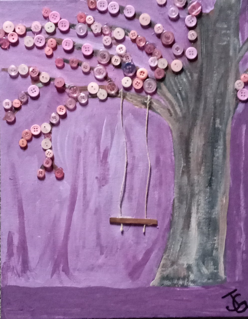 a multimedia painting shows a gray tree on a purple background. Purple buttons are affixed to the tree’s branches to form its leaves. A swing of string and a small piece of wood hangs from the lowest branch. 