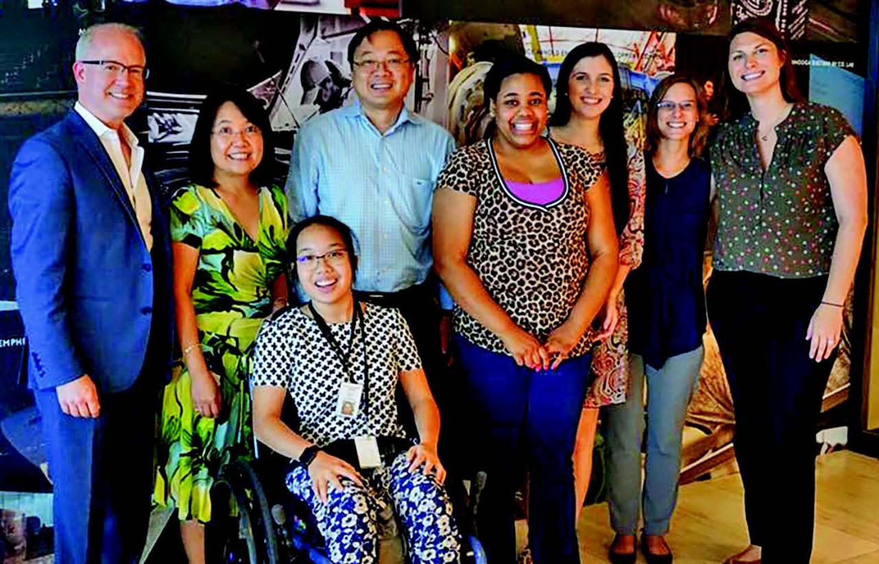 There is a group photo of eight individuals, who are the interns, their family members and job coaches. It is a very ethnically diverse group of two men and six women. One of the young women is in a wheelchair.