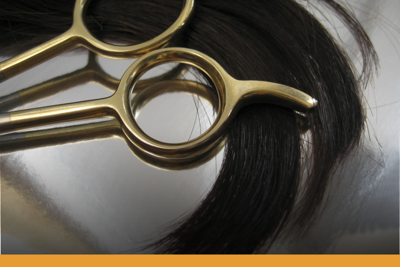 Lock of hair and handle of scissors