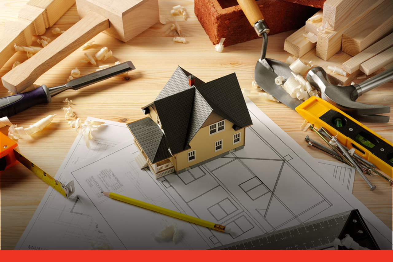 Carpentry tools and model house on top of house plans
