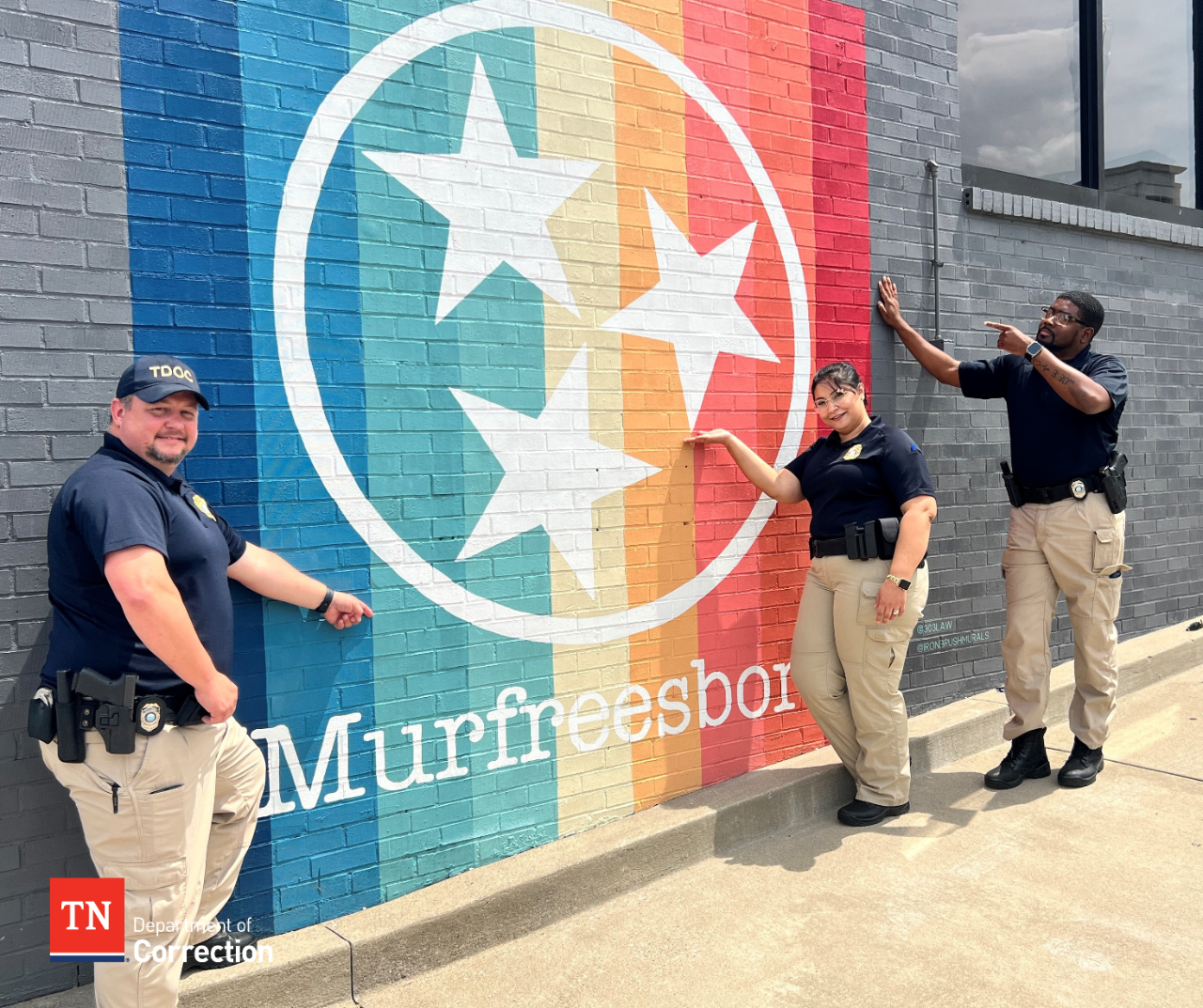 Photo of probation parole officers with Murfreesboro mural