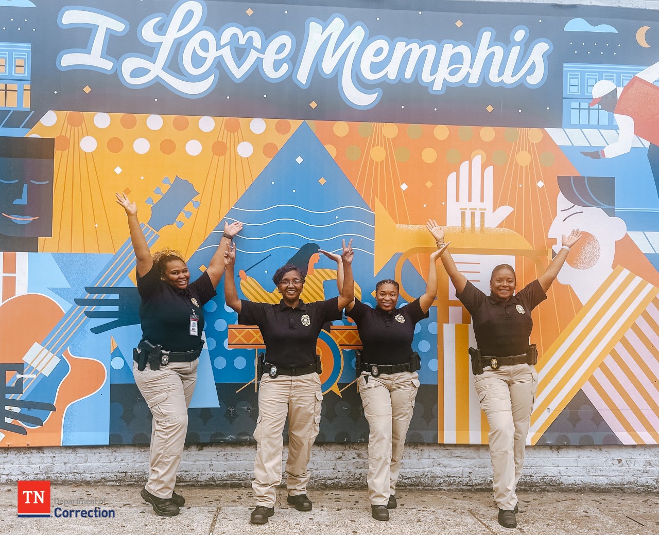 Photo of probation parole officers with Memphis mural