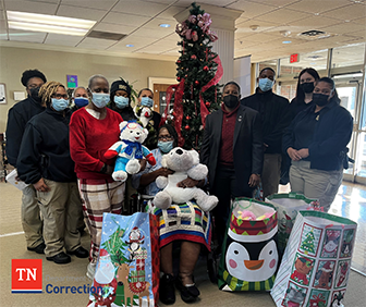 Photo of Staff in Front of Christmas Tree