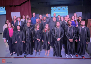 Group of Day Reporting Center Graduates in Graduation Gowns