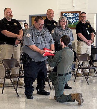 Correctional Officer Orlando Gonzalez Presented Flag Photo of Officer Receiving Folded Flag