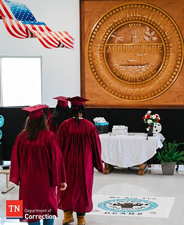 Photo of Three Offenders Walking to Receive Diploma