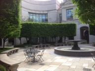 photo of outdoor courtyard with fountain and benches