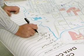 photo of writing notes on a big paper map