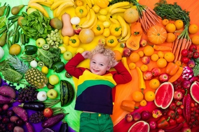 toddler among fruits and veggies