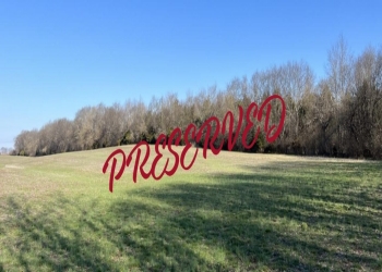 Image of a field with a tree line in the distance in the winter, known as the Smith Tract Image of a field with a tree line in the distance in the winter, known as the Smith Tract
