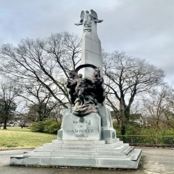 Image of a monument with two horses and a man in the winter