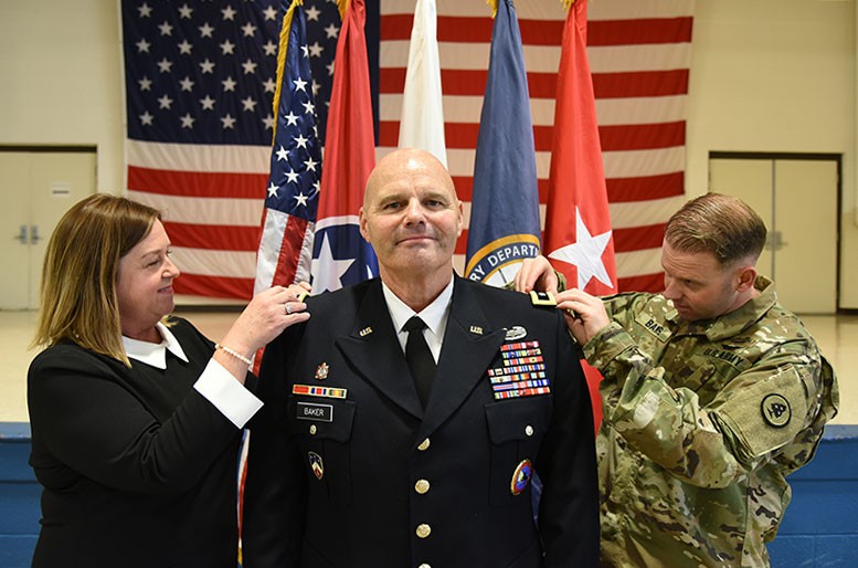 Maj. Gen. Tommy Baker is pinned with his new rank by his wife Camille and his son