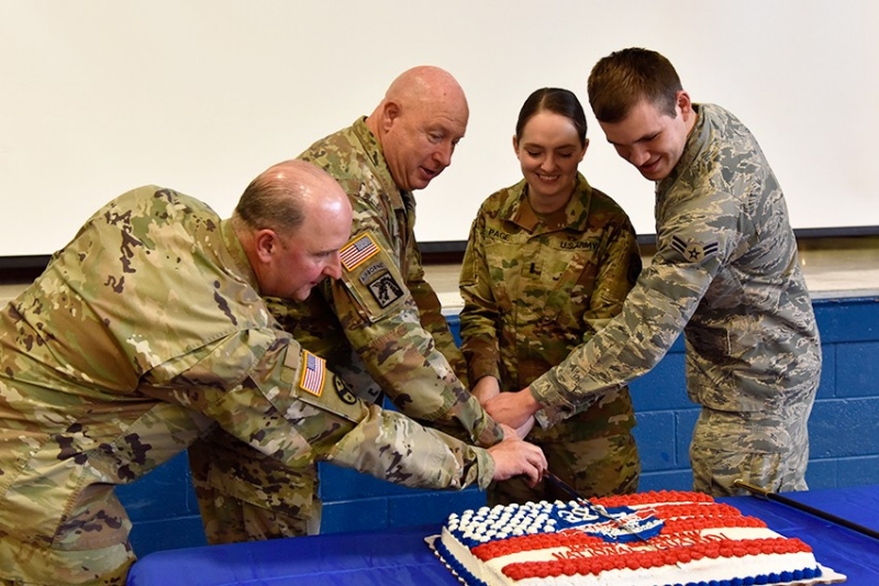 Maj. Gen. Max Haston, Tennessee’s Adjutant General, cuts a National Guard birthday cake with a ceremonial saber and is joined by Chief Warrant Officer 5 Lee Kies, 1st Lt. Margaret Page, and Airman 1st Class Antonio Romero to celebrate the National Guard’s 382nd birthday on December 13 at the Tennessee National Guard Headquarters. 