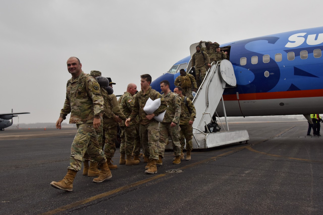 278th ACR Soldier return from Poland Soldier coming off of a plane on airport runway