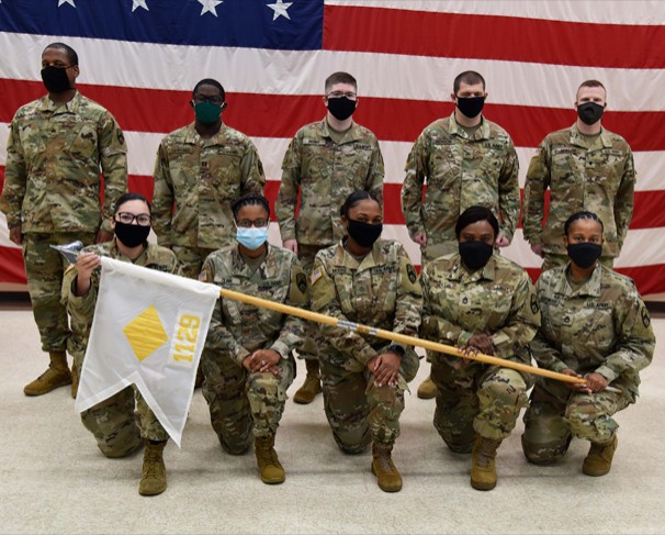 Group of Soldiers holding unit flag
