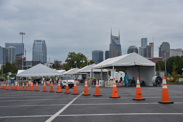 COVID-19 drive-thru testing site with the skyline of the city of Nashville in backdrop 