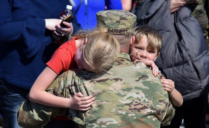 Soldier hugging his children