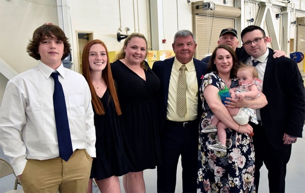 Col. James “Doc” Cooper poses with his family during his retirement ceremony