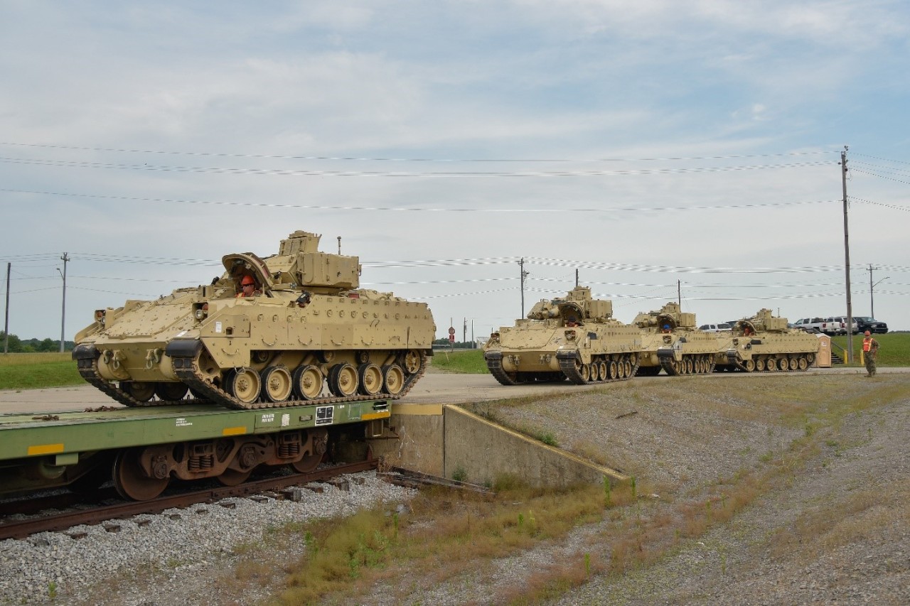 Soldiers from the 278th Armored Cavalry Regiment load Bradley Fighting Vehicles onto trains, June 21, at Fort Campbell. Approximately 1,000 vehicles, tanks and pieces of equipment are being loaded onto trains in preparation for XCTC, a three-week training exercise that will be taking place in Fort Hood over the summer. (Photo by Sgt. 1st Class Timothy Cordeiro)