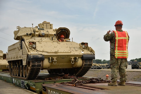Soldiers assigned to the 278th Armored Cavalry Regiment load a Bradley Fighting Vehicle onto a train in preparation for movement to Fort Hood, Texas, June 21. Approximately 1,000 vehicles, tanks and pieces of equipment are being loaded onto trains in preparation for XCTC, a three-week training exercise that will be taking place in Fort Hood over the summer. (Photo by Sgt. 1st Class Timothy Cordeiro)