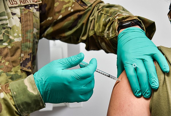 2nd Lt. David Wenger, a clinical nurse with the 134th Medical Group in Knoxville, administers a COVID-19 vaccine shot on May 2. (Photo by Tech. Sgt. Teri Eicher)
